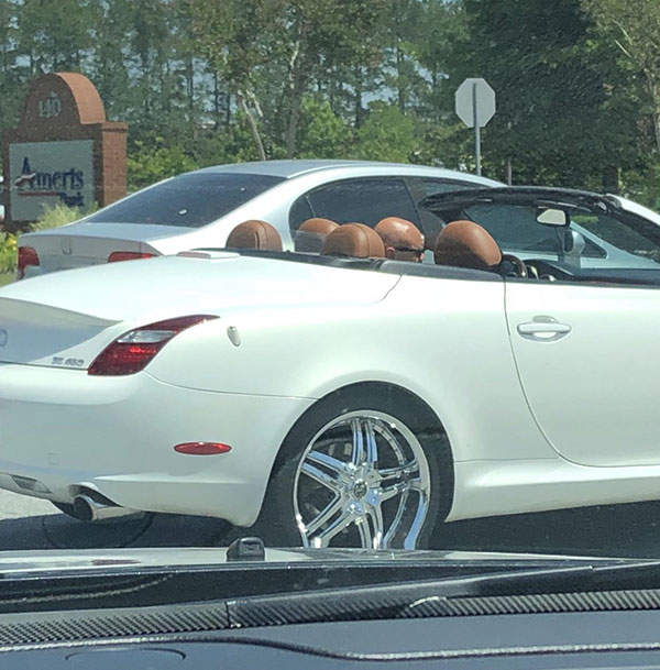 Bald friends in a convertible