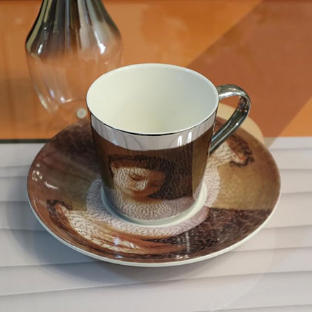 Anamophic mirror cup and saucer