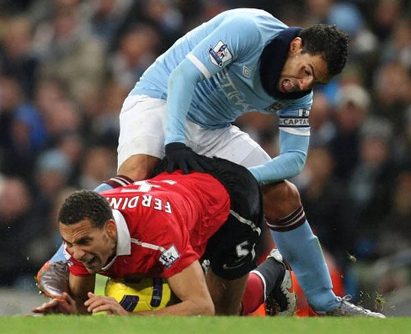  What does your dirty mind think of this unfortunately timed photo of Carlos Tevez and Rio Ferdinand during a match in 2010.