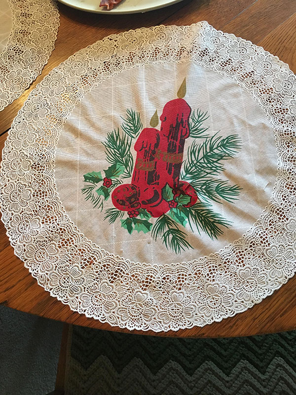 Grandma's placemats with a christmas candle show a dirty optical illusion