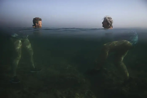 This optical illusion by Alexandre Meneghini of two women with big bottoms swimming in Cuba in 2015 is a classis example of refraction.