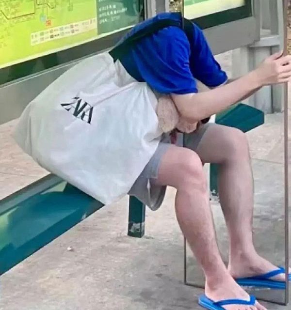 Headless man at bus stop in Singapore