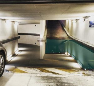 Surreal puddle at a parking garage creates an optical illusion