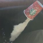 milk splashing or dog with head in cup